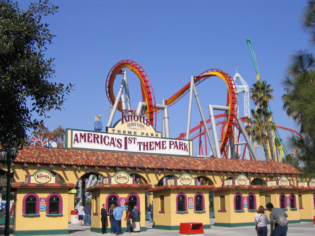 Entrance area at Knott’s Berry Farm with the park sign and roller coaster visible behind it.